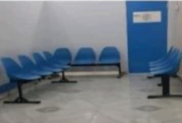 Empty waiting area with rows of blue chairs