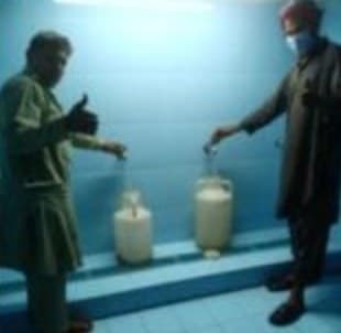 Two men filling water cans at Water Plant 1